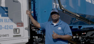 Western Elite employee standing with his truck, looking at the camera and giving a thumbs up.
