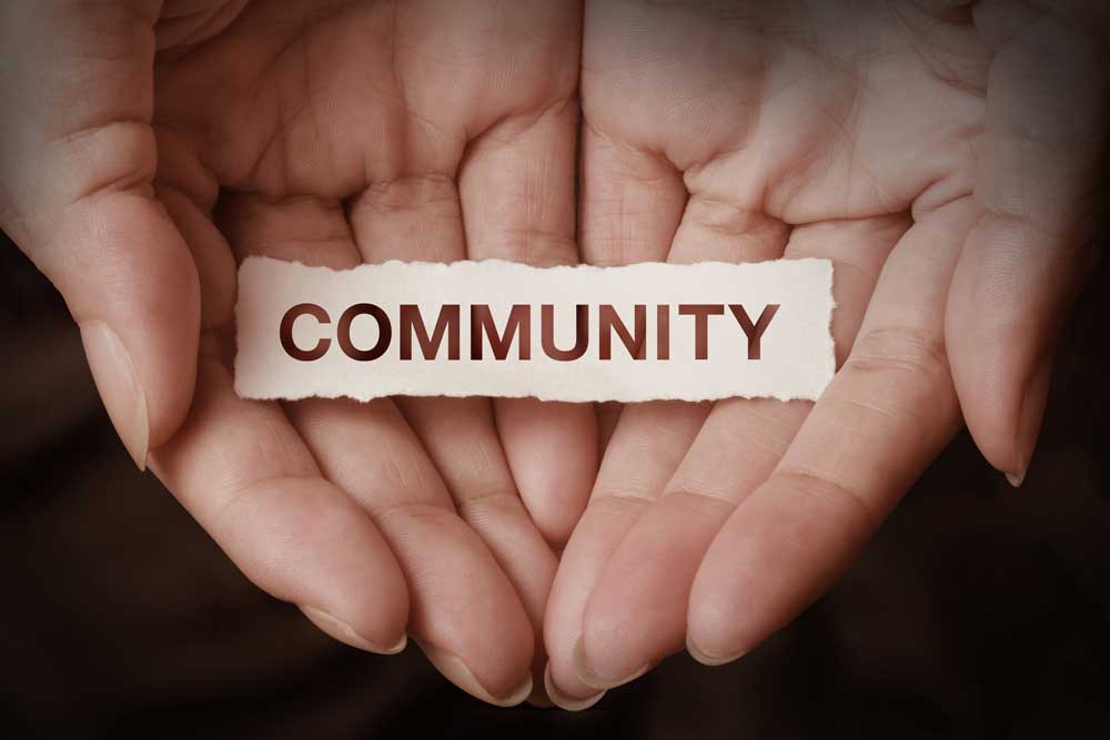 hand holding the word community
