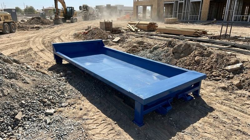 Western Elite blue concrete washout container staged on an active construction site